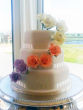 Three tier hexagonal white wedding cake