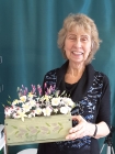 Picture of a senior citizen after completing her Handcrafted sugar flower workshop   