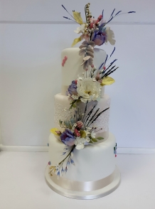 Cambridge Wedding Cakes three tiers with handcrafted sugar flowers cascading down the cake