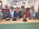 a group of pupils with Yvonne their tutor showing their chocolate cakes finished