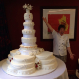 Yvonne the business owner showing off her 14 tier cake